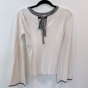 Soft cream sweater w/ adorable black stripe tie-neck & bell sleeves.